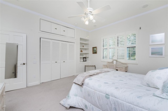 carpeted bedroom featuring ornamental molding, a closet, and ceiling fan