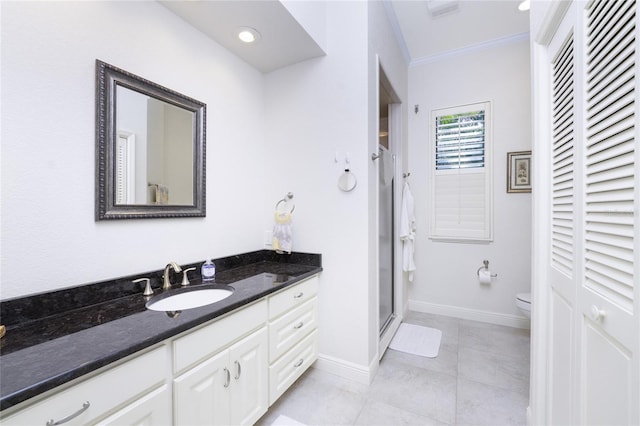 bathroom featuring vanity, crown molding, a shower with shower door, tile patterned floors, and toilet