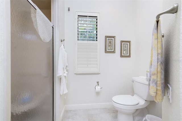 bathroom with toilet, tile patterned floors, and a shower with door