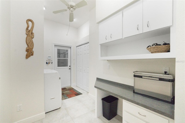 interior space with light tile patterned flooring, ceiling fan, and washer / dryer