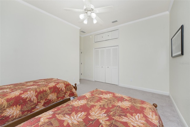 bedroom featuring light colored carpet, ceiling fan, crown molding, and a closet