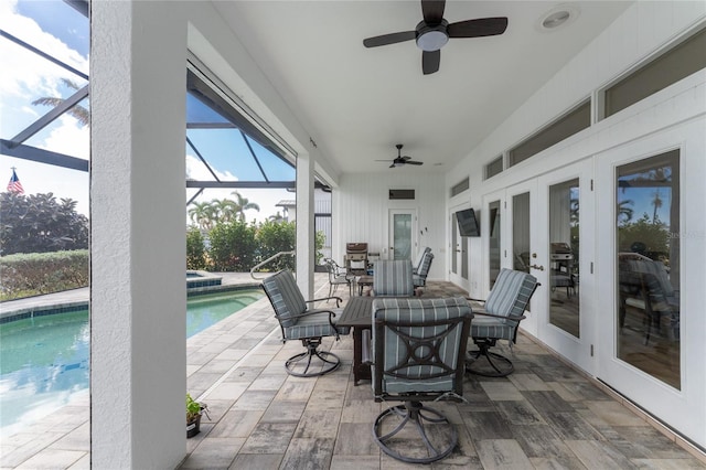 view of patio / terrace with glass enclosure, french doors, and ceiling fan