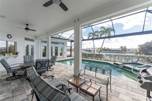 view of swimming pool with a patio, ceiling fan, and glass enclosure