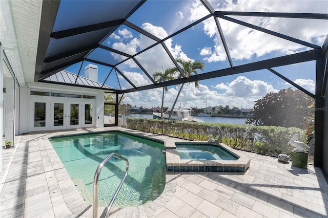 view of pool with a water view, glass enclosure, an in ground hot tub, and a patio area