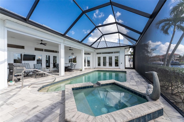 view of pool with french doors, an in ground hot tub, glass enclosure, a patio, and ceiling fan