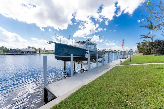 dock area featuring a lawn and a water view