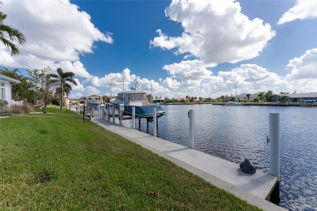 view of dock featuring a water view and a lawn