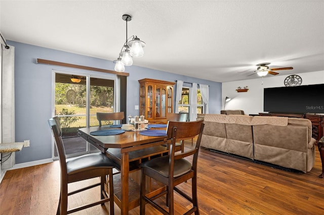 dining space with a textured ceiling, dark hardwood / wood-style floors, and ceiling fan