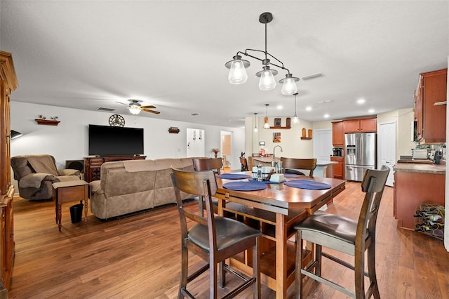 dining room with hardwood / wood-style flooring and ceiling fan