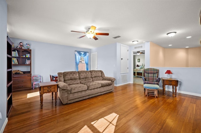 living room featuring hardwood / wood-style floors and ceiling fan