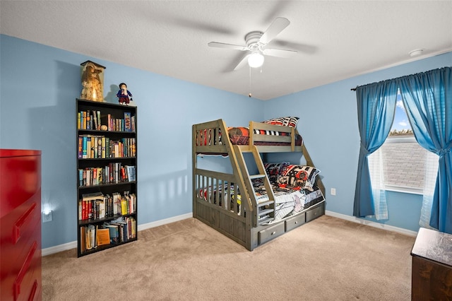 carpeted bedroom with a textured ceiling and ceiling fan