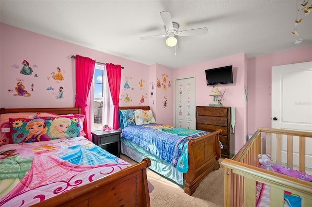 carpeted bedroom with a closet and ceiling fan