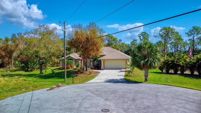 view of front of house with a front yard and a garage