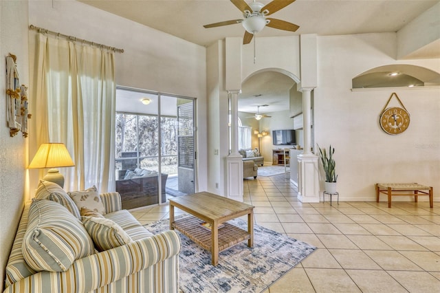 tiled living room featuring decorative columns and ceiling fan