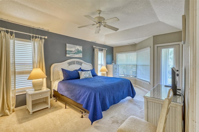 bedroom featuring a textured ceiling, ceiling fan, lofted ceiling, and light carpet