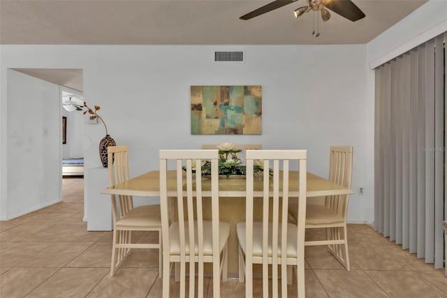 dining space with light tile patterned flooring and ceiling fan