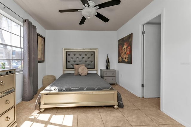 tiled bedroom featuring ceiling fan