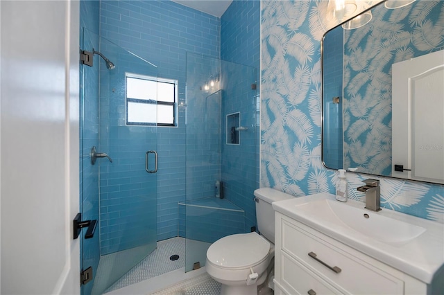 bathroom featuring vanity, toilet, and a shower with door