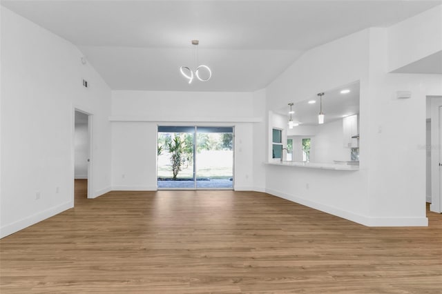 unfurnished living room with light hardwood / wood-style floors and lofted ceiling