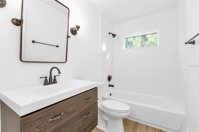 full bathroom with  shower combination, wood-type flooring, toilet, and vanity