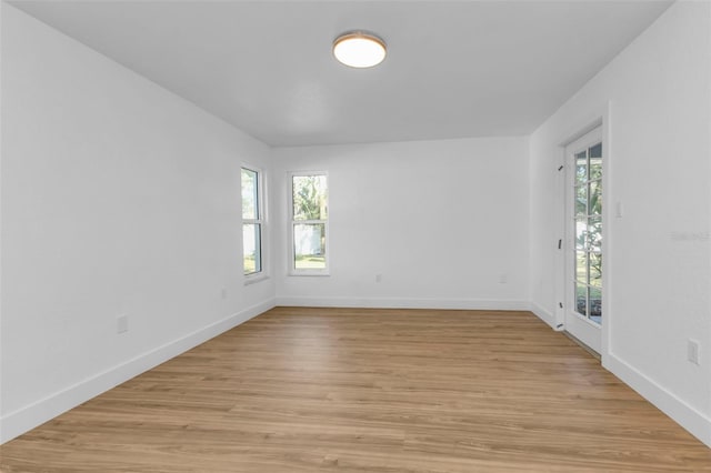 unfurnished room featuring light hardwood / wood-style flooring and a healthy amount of sunlight