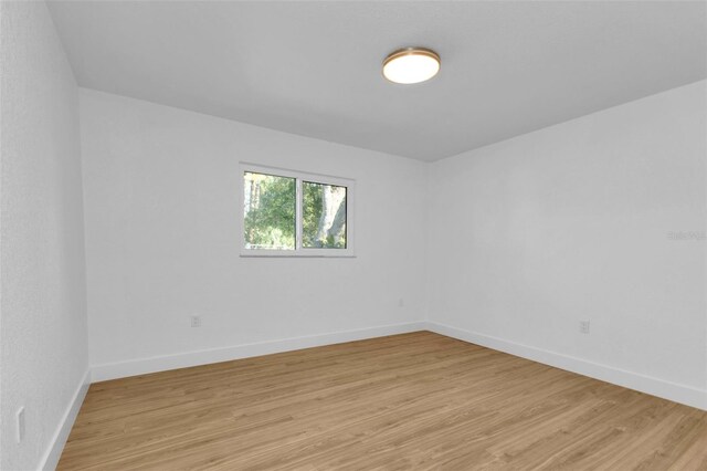 empty room with light hardwood / wood-style flooring