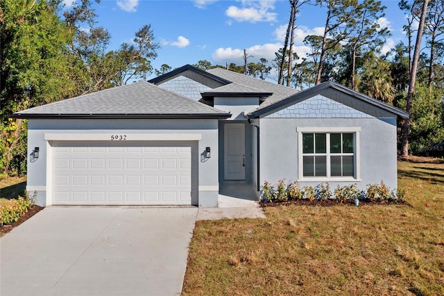 view of front of house with a front yard and a garage