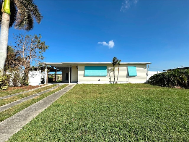 view of front of property with a front yard and a carport