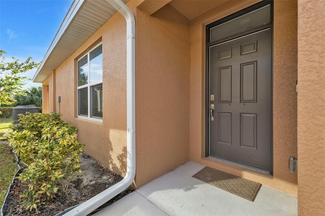 entrance to property featuring cooling unit