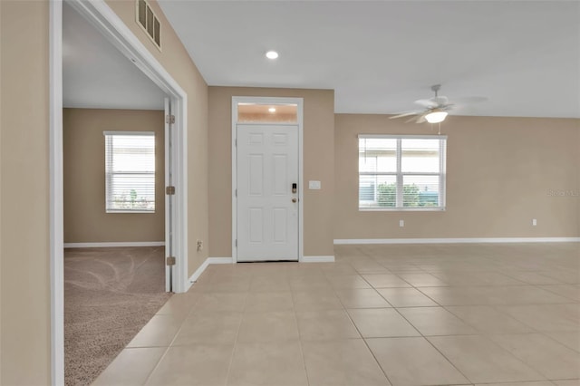 carpeted entryway with ceiling fan