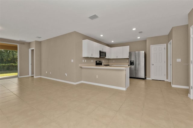 kitchen featuring kitchen peninsula, appliances with stainless steel finishes, light tile patterned flooring, and white cabinets