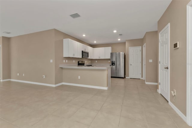 kitchen featuring white cabinets, kitchen peninsula, stainless steel appliances, and light tile patterned flooring