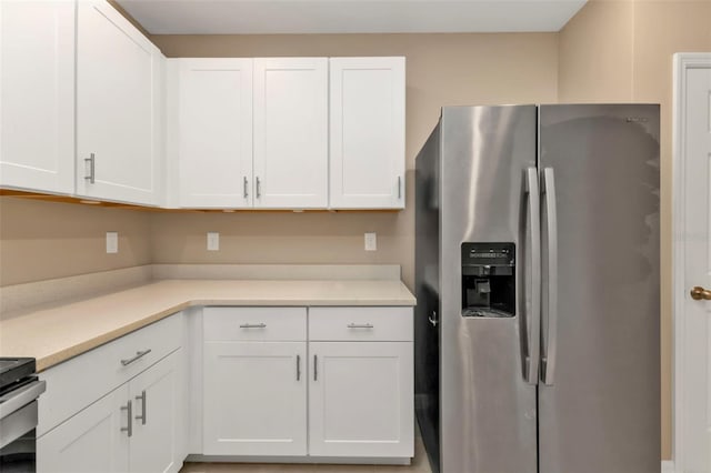 kitchen with stainless steel refrigerator with ice dispenser and white cabinetry