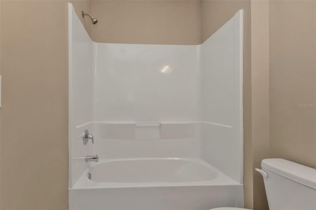 bathroom featuring  shower combination and toilet