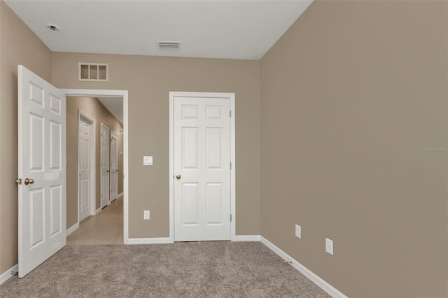 unfurnished bedroom with light carpet