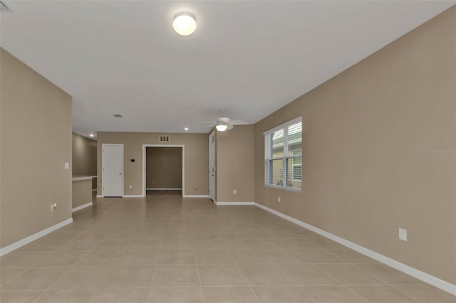 unfurnished room with light tile patterned flooring and ceiling fan