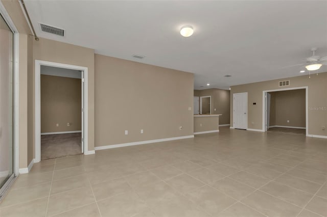 empty room featuring light tile patterned floors and ceiling fan