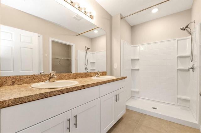 bathroom featuring walk in shower, vanity, and tile patterned floors