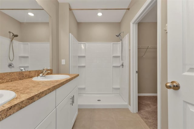 bathroom featuring vanity, tile patterned floors, and a shower