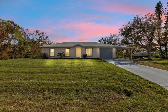 view of front of property with a garage and a lawn