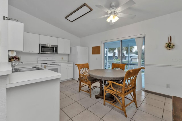 dining room with vaulted ceiling, sink, light tile patterned floors, and ceiling fan