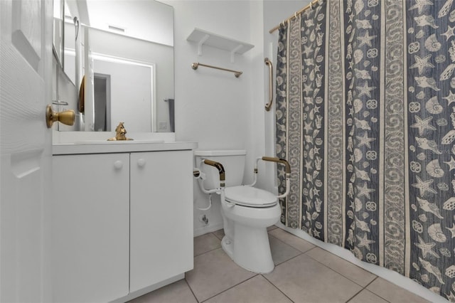 bathroom with vanity, toilet, tile patterned floors, and walk in shower