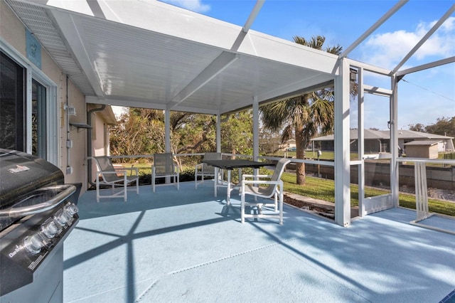 view of patio / terrace featuring area for grilling and glass enclosure