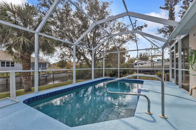 view of swimming pool featuring a patio and a lanai