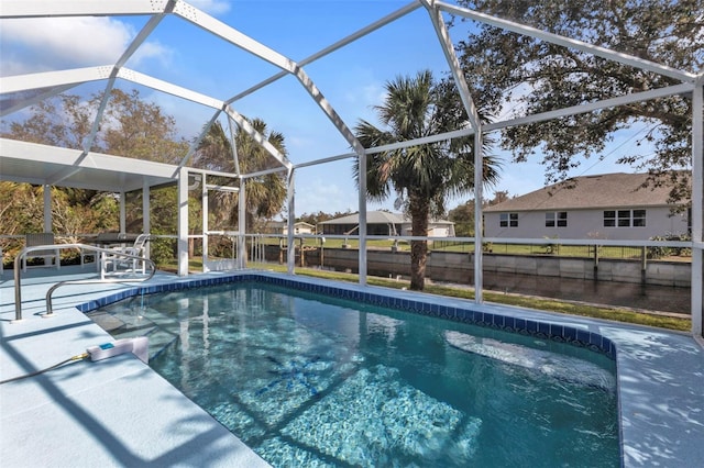 view of swimming pool featuring a patio area and a lanai