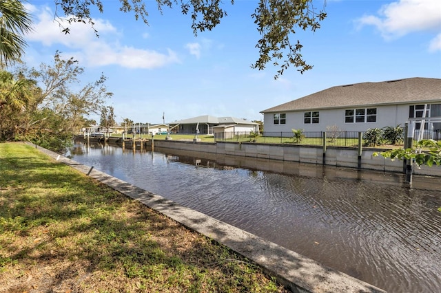 dock area with a yard and a water view