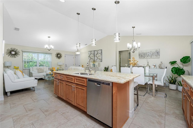 kitchen featuring lofted ceiling, sink, stainless steel dishwasher, an island with sink, and decorative light fixtures