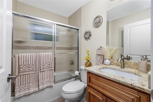 full bathroom with vanity, toilet, and combined bath / shower with glass door