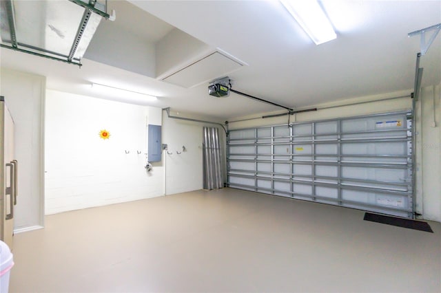 garage with electric panel and a garage door opener