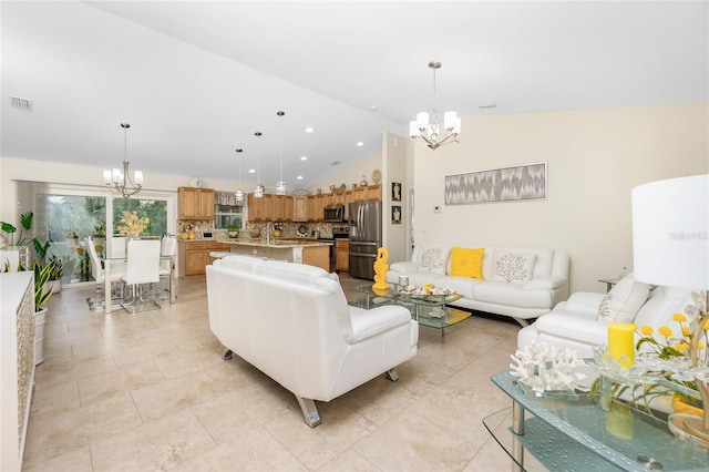 living room with lofted ceiling and a chandelier